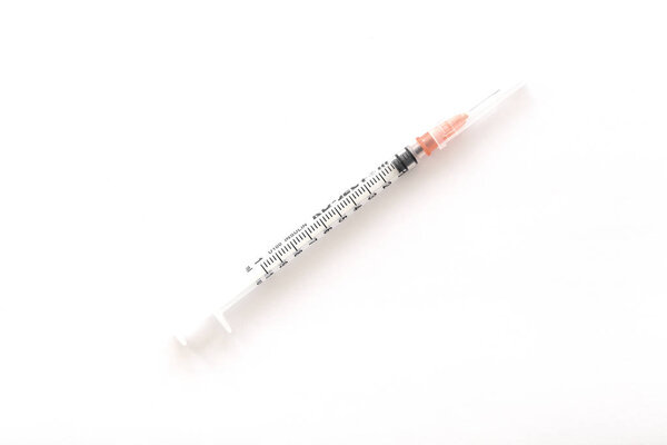 Empty syringe closeup isolated on white background.