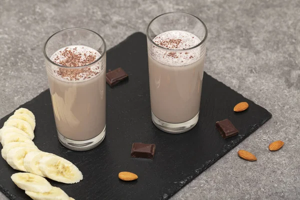 Healthy Chocolate Protein Shake with Almond Milk, banana, chocolate and nuts. Milkshake. Tasty and healthy Breakfast