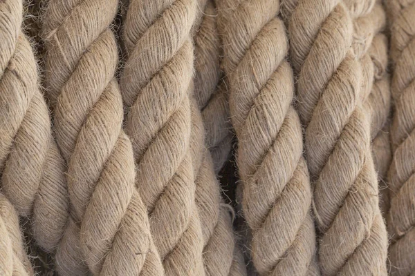 Industrial rope. Close-up rope as background - texture. Nautical rope. Closeup of an frayed boat rope. Nautical background.
