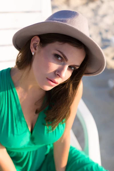 ビーチでのグリーンのドレスで美しい若い女性 — ストック写真