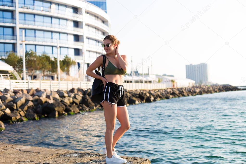 Young woman working out at the beach in the summer
