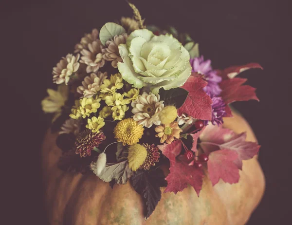 Festive Thanksgiving autumn flowers arrangement in a pumpkin