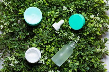 Yeşil çimen arka planında çeşitli organik kozmetik ürünleri