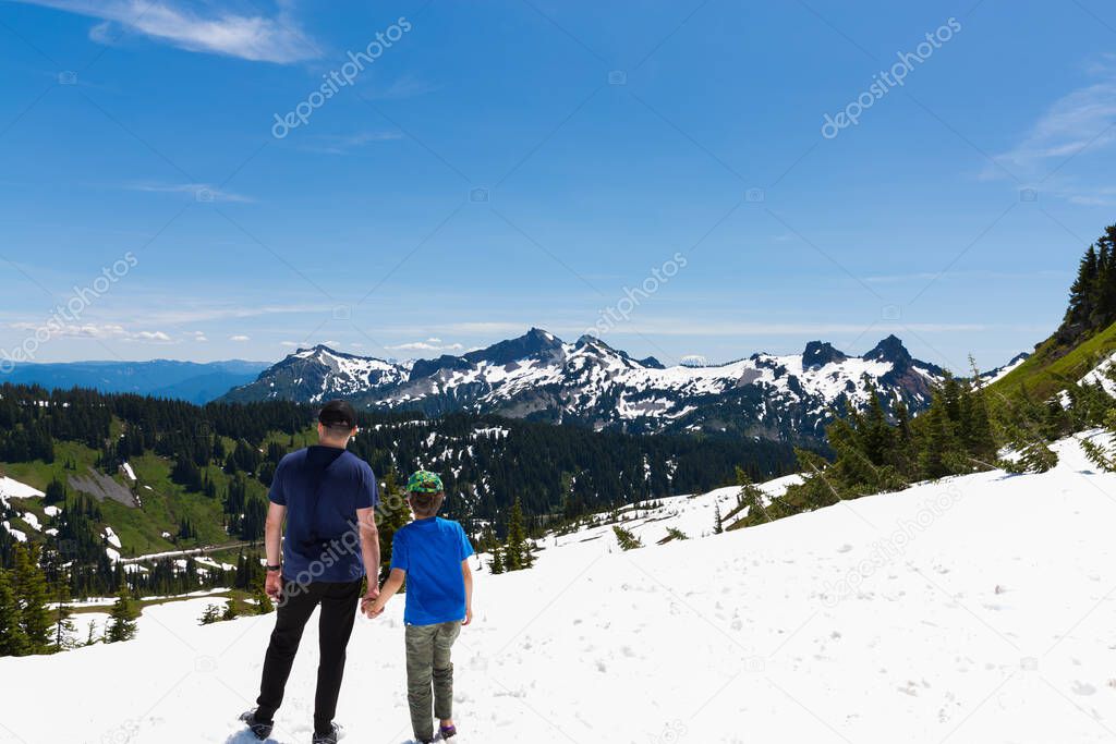 Father and son hiking at Cascade mountains, Mt. Rainier National Park