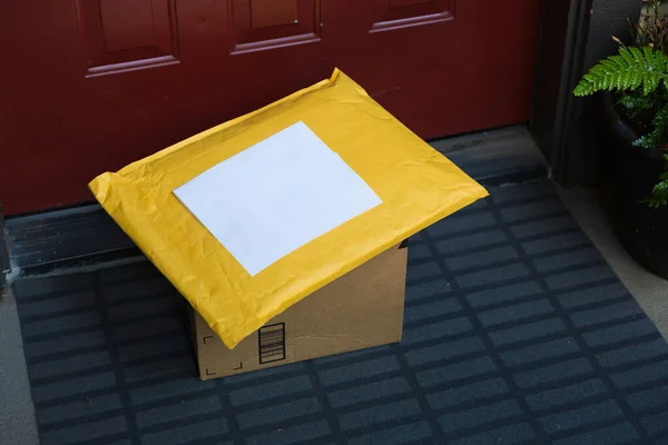 A box and a mailer on a doorstep, online order home delivery concept