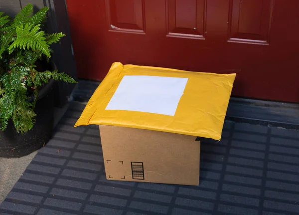 A box and a mailer on a doorstep, online order home delivery concept