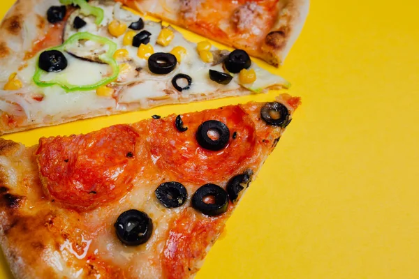 different pizza set for menu. Pizza with salami, pizza with mozzarella, salami, sausages, sliced peppers, yellow background, Top view. Banner, close-up, copy-space