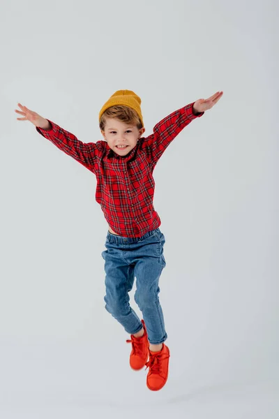Content hipster boy jumping in studio — Stock Photo, Image