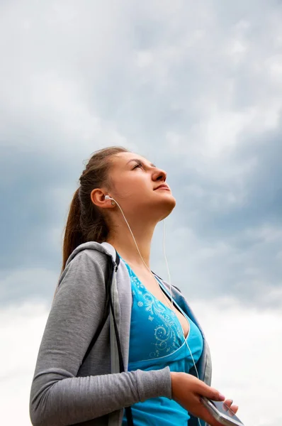 Young Beautiful Girl Runs Street in Morning Listens Music Headphones and Enjoys this Moment. Concept Healthy Lifestyle