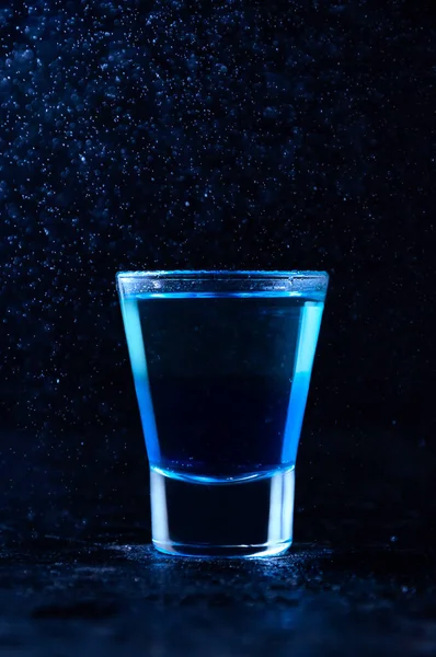 Shot with White Rum and Liquor Blue Curacao. Alcoholic Layer Cocktail in Freeze Motion, Drops in Liquid Splash on Dark Background — Stock Photo, Image