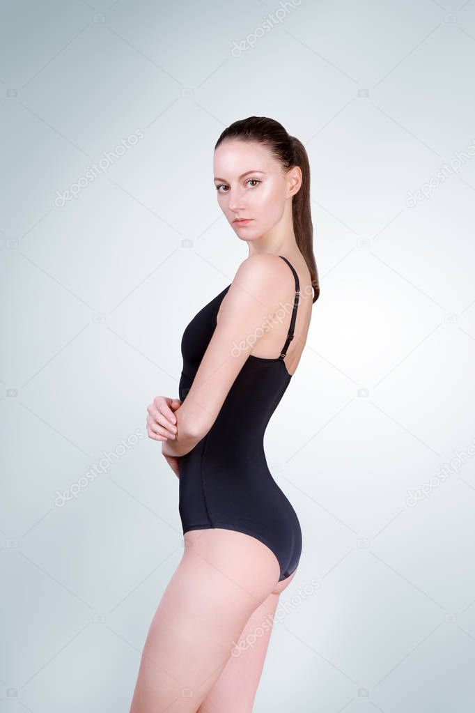 Fashion woman. black bikini bathing suit. Posing model test snaps in white background studio