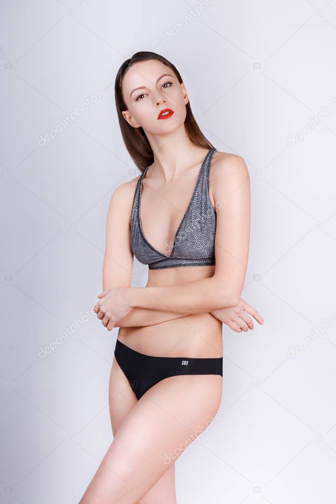 Fashion woman. black bikini bathing suit. Posing model test snaps in white background studio