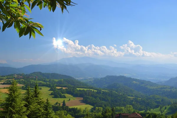 Sun in the cloud as in hand, summer landscape — Stock Photo, Image