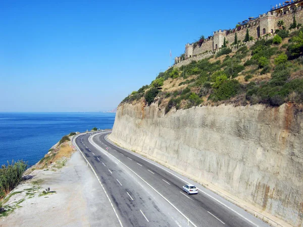 Inspiring view of the Mediterranean sea and the road against the backdrop of a cliff in the Mahmutlar region. Alanya, Turkey
