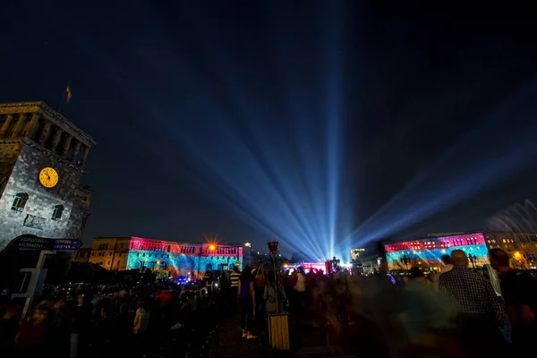 Beautiful light show during a concert at night. Republic Square in Yerevan, Armenia. Celebration The Day of Armenian First Republic on May 28. (Streets names are written in Armenian and English on the blue sign)