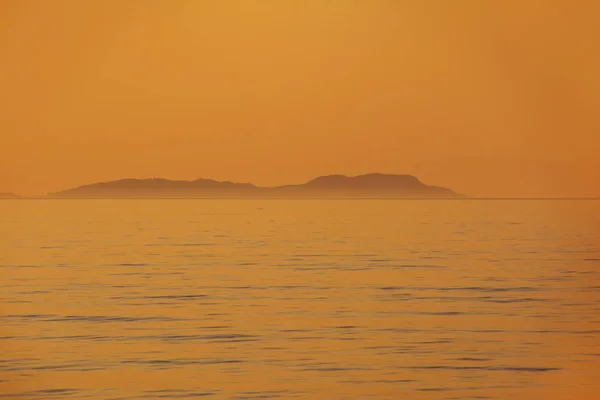 Beautiful sea sunset with island silhouette panorama. View of Ereikoussa island from Corfu island in Greece