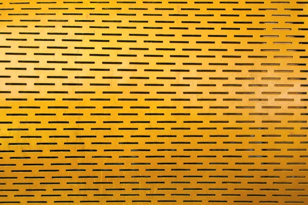 Yellow steel mesh screen background and texture. Abstract pattern of repousse painted metal sheet