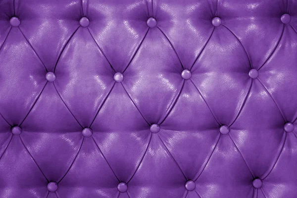 Texture of genuine purple leather upholstered furniture. Decorative background of genuine quilted leather capitone texture