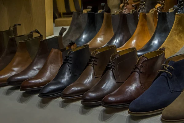 Row of leather mens shoes on shelf. Mens shoes, boot sell in store, boutique, shopping mall. Mens shoes concept. Mens fashion, style, quality, leather, leatherette