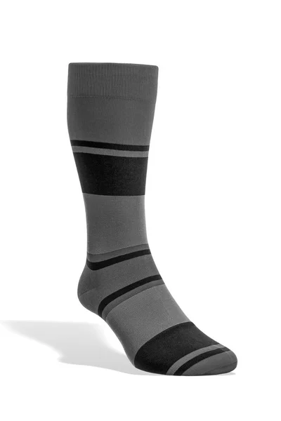 Μία Κάλτσα Μαύρο Και Γκρι Ρίγες Στέκεται Ένα Λευκό Φόντο — Φωτογραφία Αρχείου