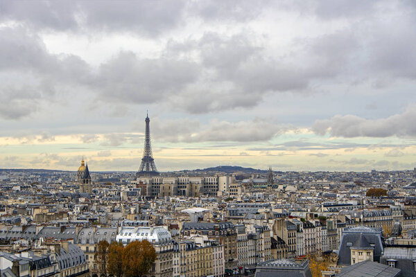 Bird eye panoramic view from Notre Dame Cathedral of Paris under the dramatic cloudy sky