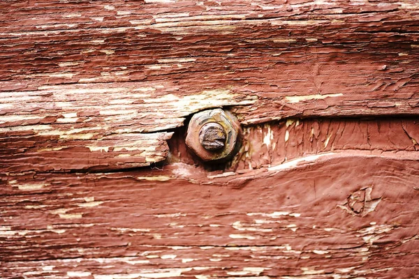 Pintura descascando velha em uma superfície de madeira. fundo da parede retro pintado em tinta vermelha — Fotografia de Stock