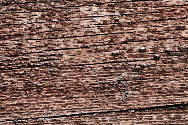 Старая пилинговая краска на деревянной поверхности. фон стены, окрашенной красной краской — стоковое фото