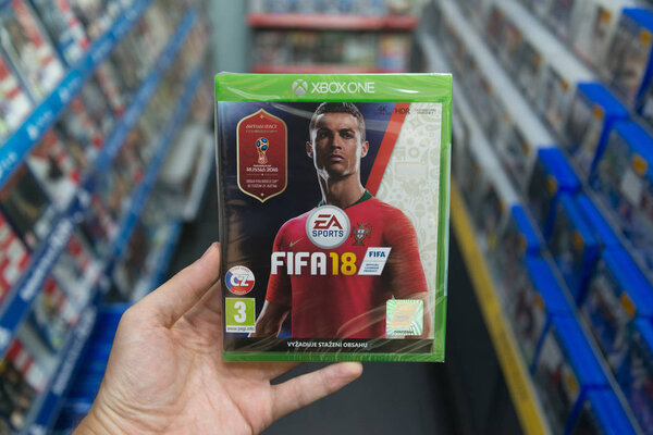 Bratislava, Slovakia, circa may 2018: Man holding Fifa 18 with Russia World Cup 2018 cover videogame on Microsoft XBOX One console in store