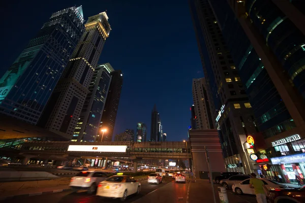 stock image ABU DHABI - JUNE 16, 2014 - Dubai downtown night scene with buildings, cars and glowing lights, UAE  