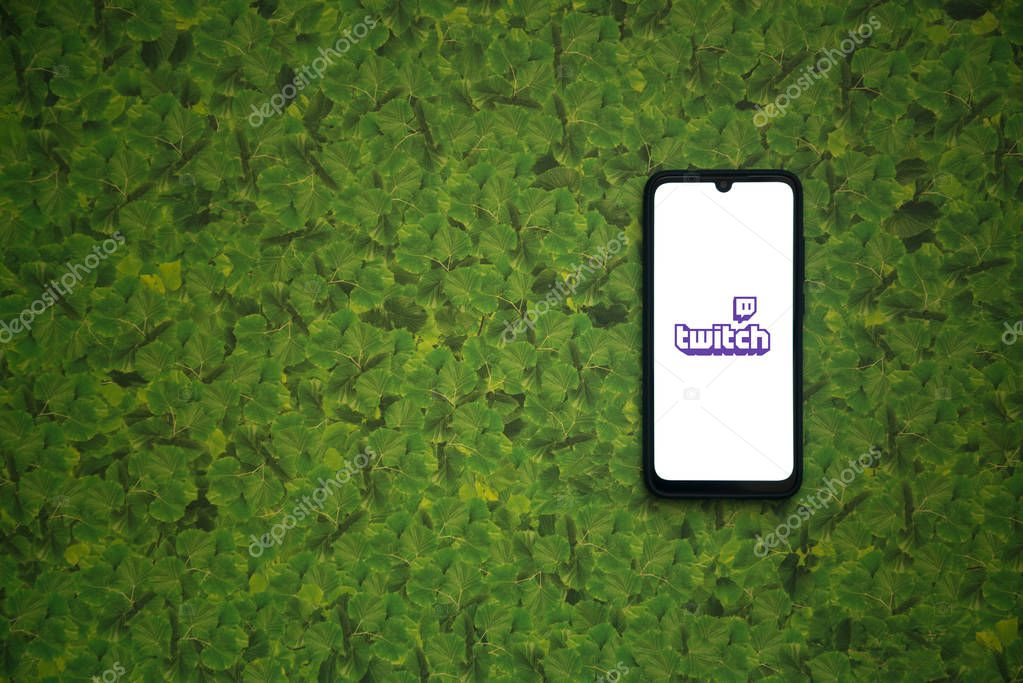 Bratislava, Slovakia, april 8, 2019: Twitch logo on smartphone screen on green leaves background.