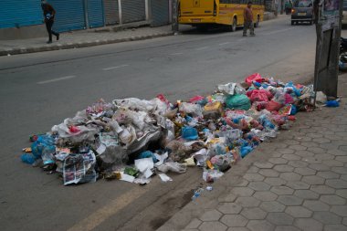 lot of garbage in the street on background