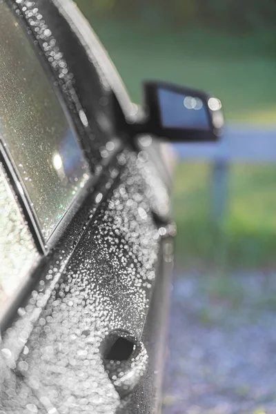 雨后黑色汽车水滴中的太阳反射 — 图库照片