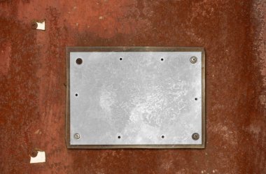 Paslı yüzeyde plastikle kaplanmış beyaz kağıt parçası