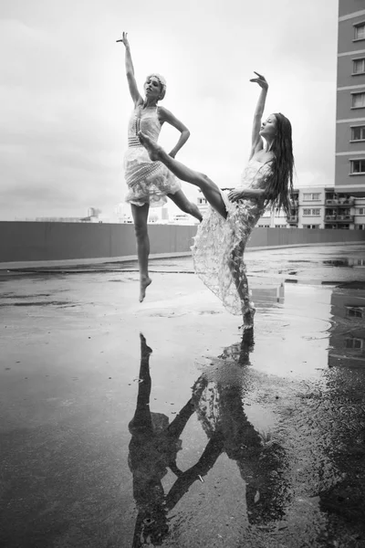 portrait of young beautiful women dancing in the rain