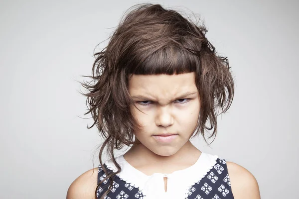 Portrait Scowling Little Girl Stylish Hairdo Looking Camera Isolated White — Stock Photo, Image