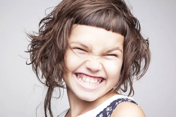幸福微笑的小女孩的肖像与时尚的发型孤立在白色背景 — 图库照片