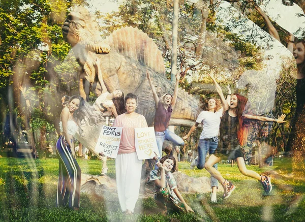 Asian woman in the park next to a dinosaur with a poster \