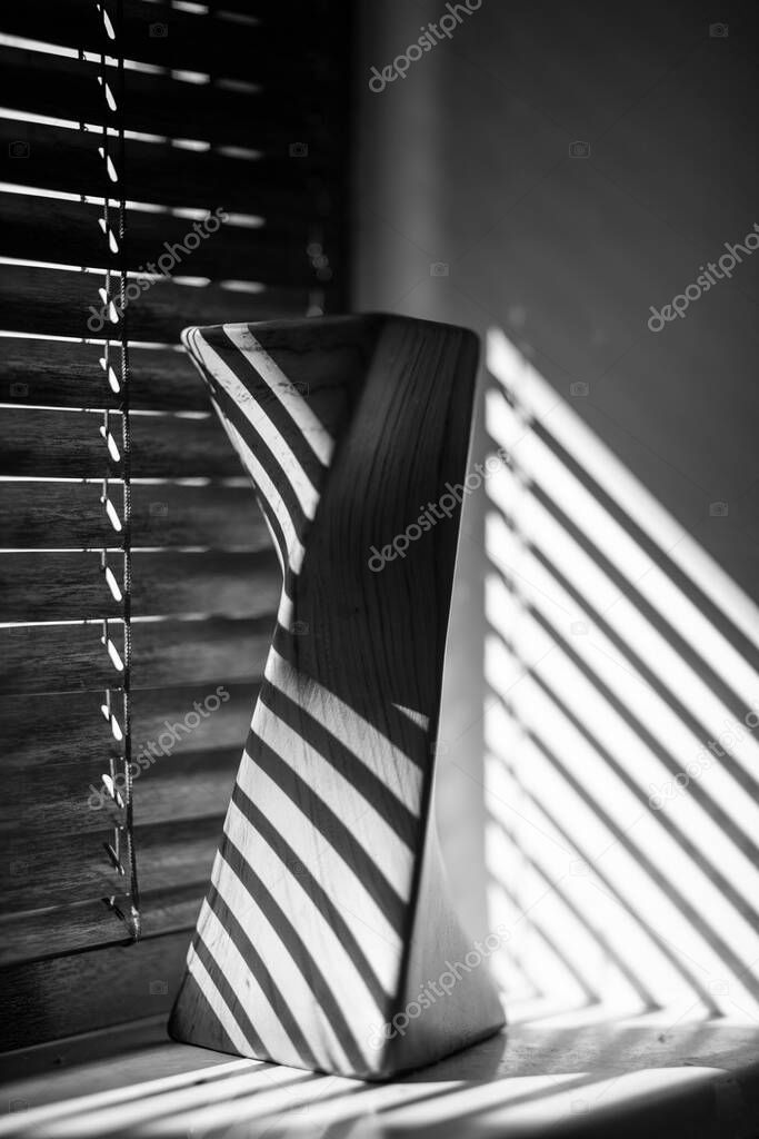 Monochrome Venetian blind with vases on window sill back light by the sun