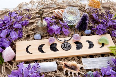 Full Moon Witch Pagan Moon Phases Altar with crystals of selenite and amethyst, with candle, pentacle and purple flowers clipart