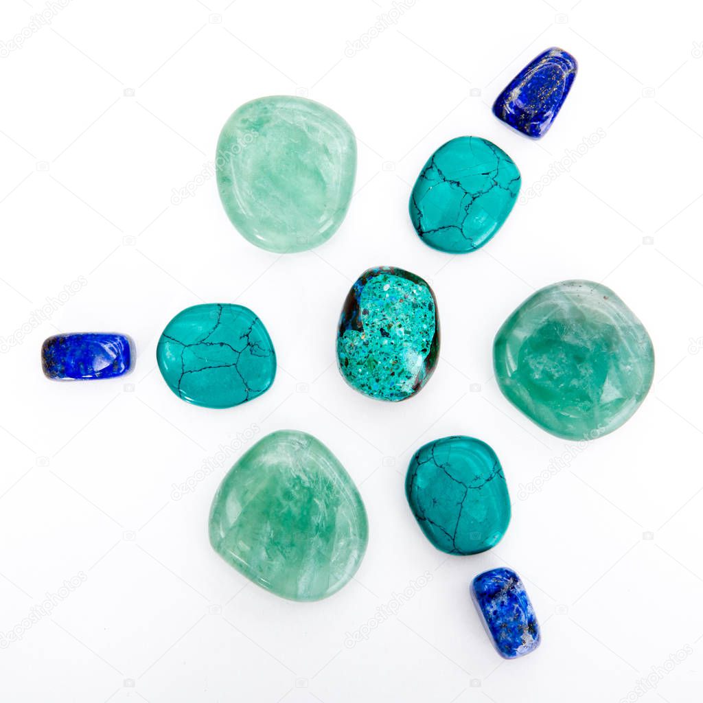 Crystal healing grid - chrysocolla, lapis lazuli, and flourite crystals on white background