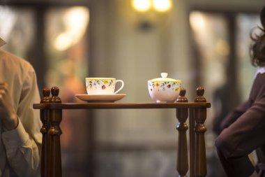 Plastik erkek ve kadın çay veya kahve içme. Piknik. Serin havalarda sıcak içecek. Bir kafede kahve fincanı ile mutlu çift. Aşk hikayesi kavramı