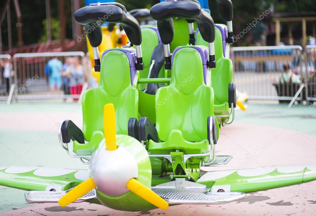 Toy plane carousel in empty amusement park