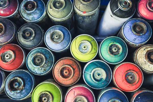 Spray cans photographed from above, you see all the colors usable.