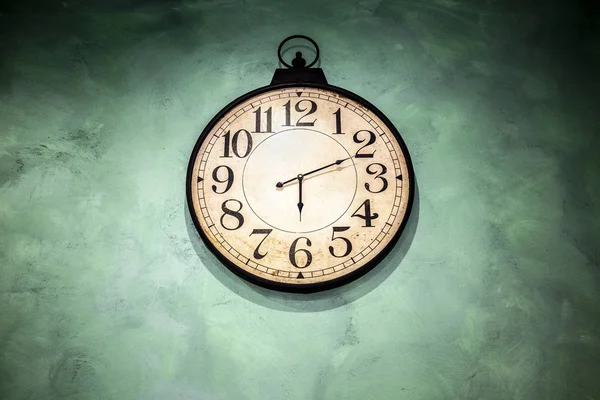 Vintage ρολόι κρέμεται σε πράσινο τοίχο — Φωτογραφία Αρχείου