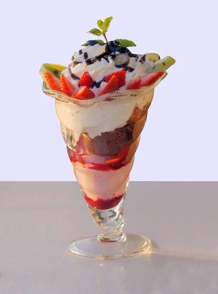 ice cream with sauce and fruits as delicious dessert