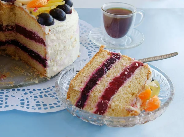tasty cake with fruits and cup of coffee