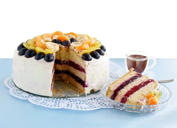 tasty cake with fruits and cup of coffee