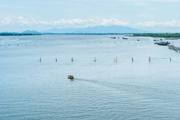 Boat running on the sea with fisherman\'s farm