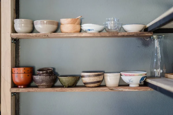 Wood shelf with ceramic bowl and cup closeup