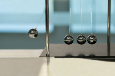 Balancing Balls Newton's Cradle on blurred backgrounds clipart